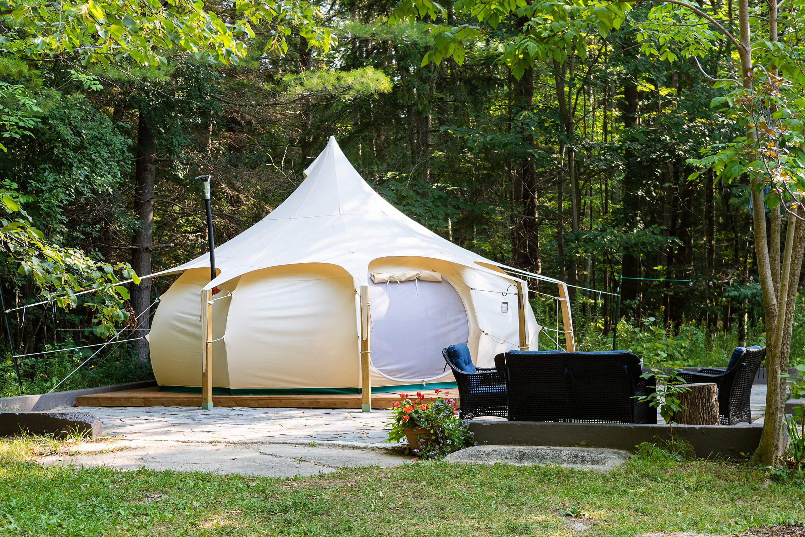 Glamping bell tent with outdoor furnature.