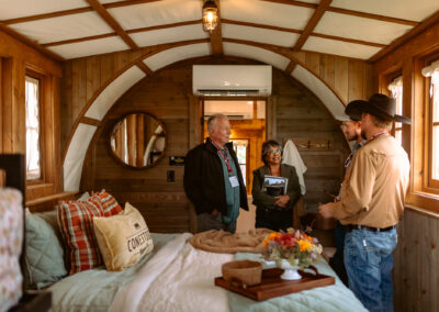 Glamping operators chat inside a Conestoga wagon at Glamping Show Americas.