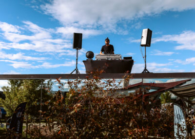 A DJ is spinning tunes from atop the Ood Mirrored House.