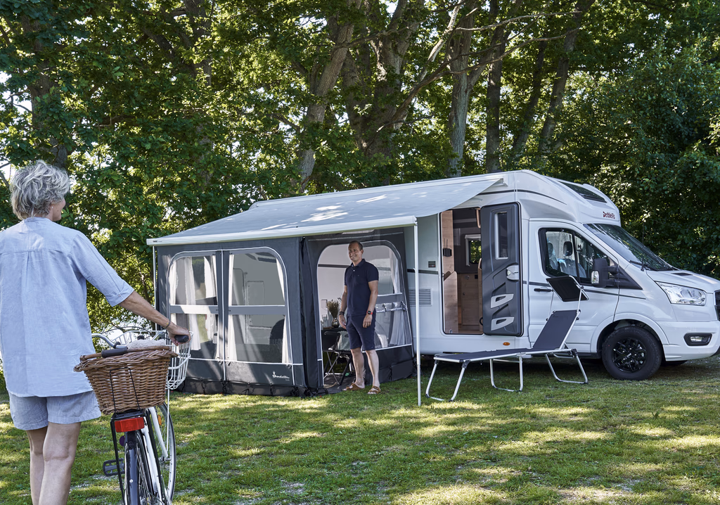 A lightweight Camp-Let tent trailer from Isabella Camping unfolded into a spacious outdoor setup, showing sleeping compartments and a central living area designed for comfortable, mobile camping.