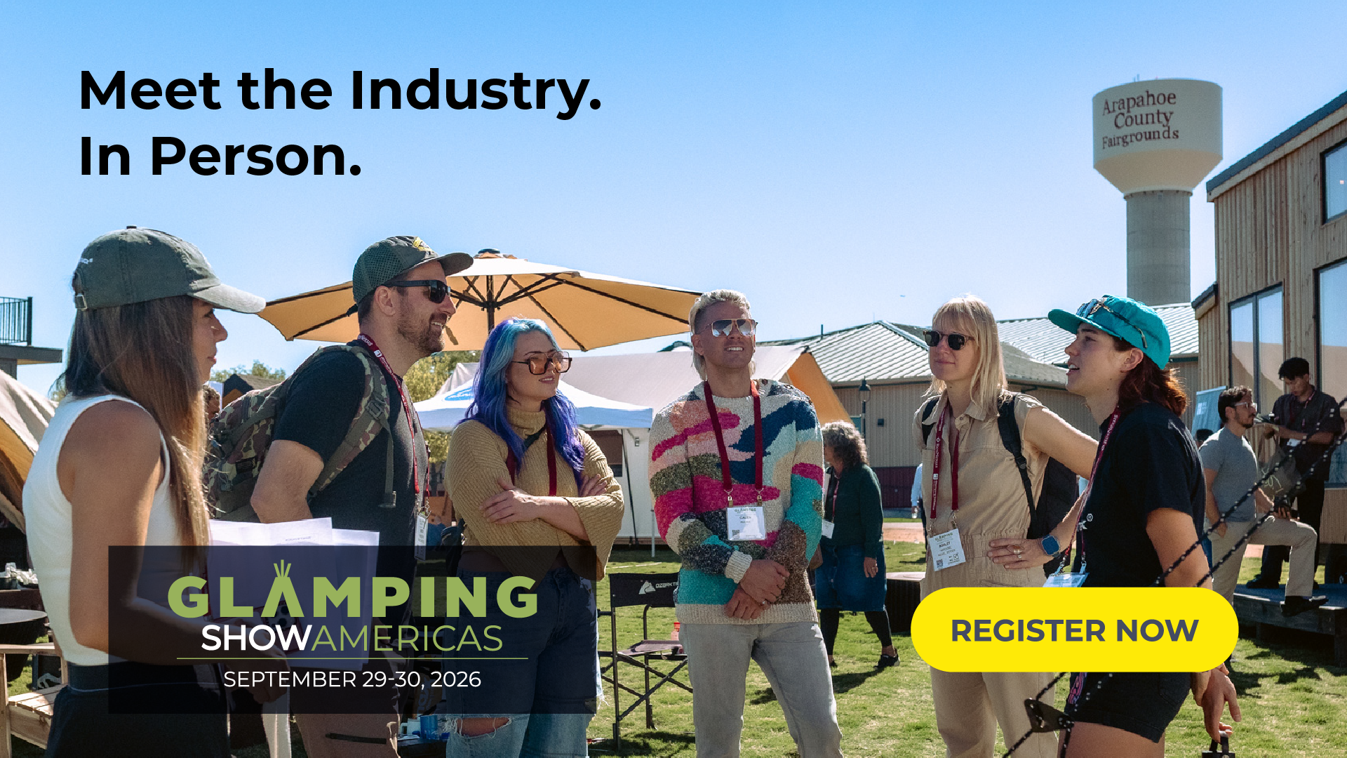 Promotional graphic for Glamping Show Americas showing attendees networking and talking outdoors among glamping structures at the show. Text reads: "Meet the Industry. In Person." Includes the Glamping Show Americas logo, event dates (September 29–30, 2026) and a "Register Now" call-to-action button.